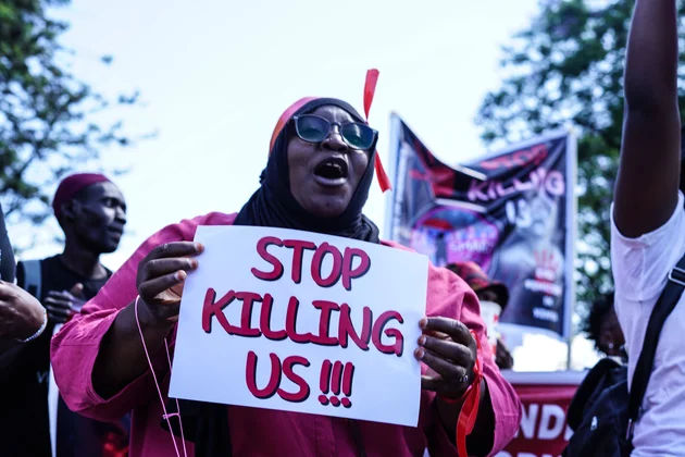 Protest against femicide in Nakuru, Kenya - 27 Jan 2024 A protester marches while holding a placard during the demonstration. 