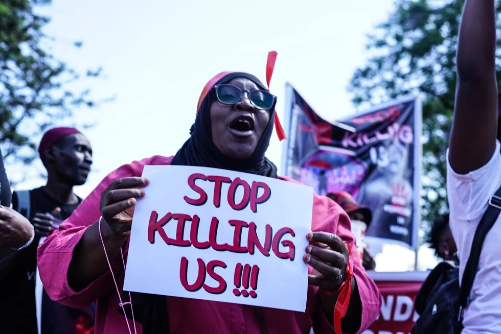 Protest against femicide in Nakuru, Kenya - 27 Jan 2024 A protester marches while holding a placard during the demonstration. 